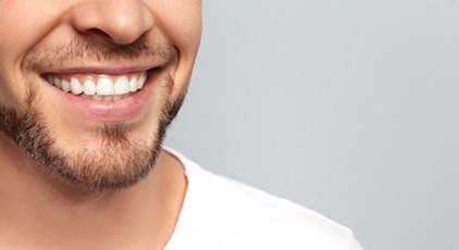 man smiling after getting dental crowns in Kernersville