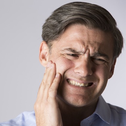 Man with jaw pain before treatment for T M J and bruxism
