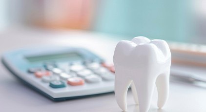 Large model tooth next to calculator