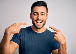 Man pointing to his smile