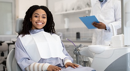 Woman smiling while sitting in treatment chair