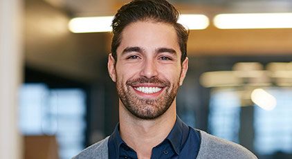 Man with metal free dental restorations smiling vibrantly