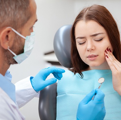 Pained woman visiting her Kernersville emergency dentist