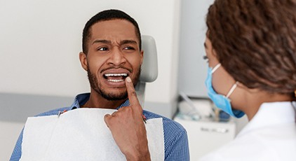 Man pointing his dental emergency in Kernersville out to his dentist