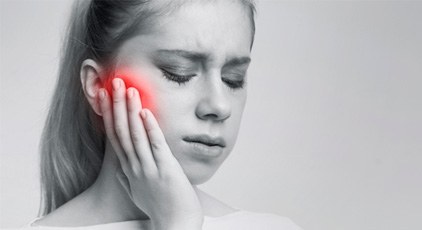 A woman suffering from dental implant failure
