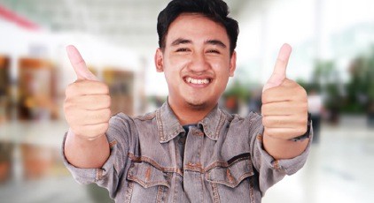 Smiling man with thumbs up after nitrous oxide dental relaxation