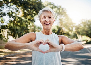 Lady makes shape of heart with her hands