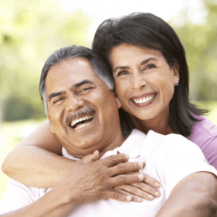 Couple embracing at the park after root canal therapy