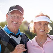 Couple outside smiling after restorative dentistry