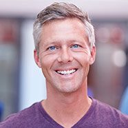 Man smiling after dental implant tooth replacement