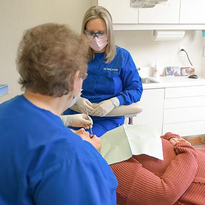 Dr. Walker performing dental checkup and teeth cleanings