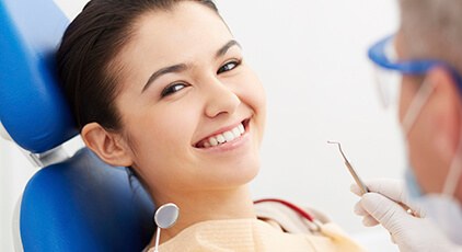 Woman receiving dental checkup and teeth cleaning