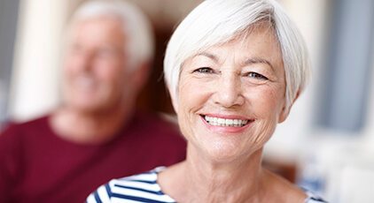 Older man and woman with dentures and partials smiling