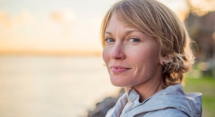 Woman smiling after gum disease treatment