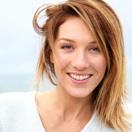 Woman with porcelain veneers smiling