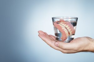 dentures in a cup of water