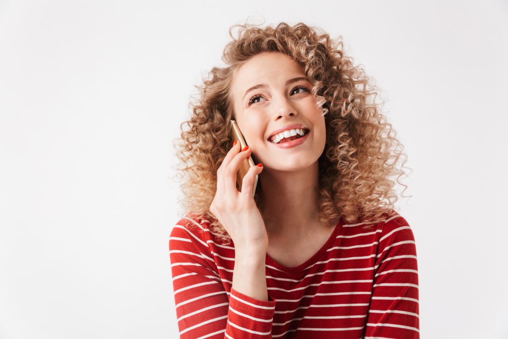 woman smiling talking on the phone