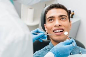 man getting oral exam with dentist in Kernersville