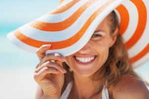 Woman in sunhat smiles after visiting her Kernersville dentist