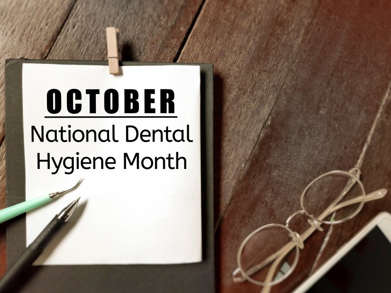 An announcement for Dental Hygiene Month on a clip board