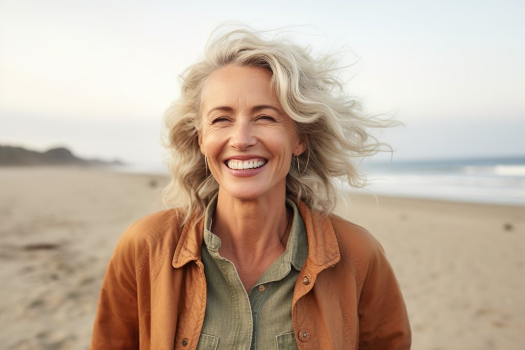 Woman smiling while walking on beach