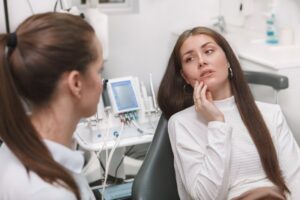Woman with a toothache at her emergency dental visit